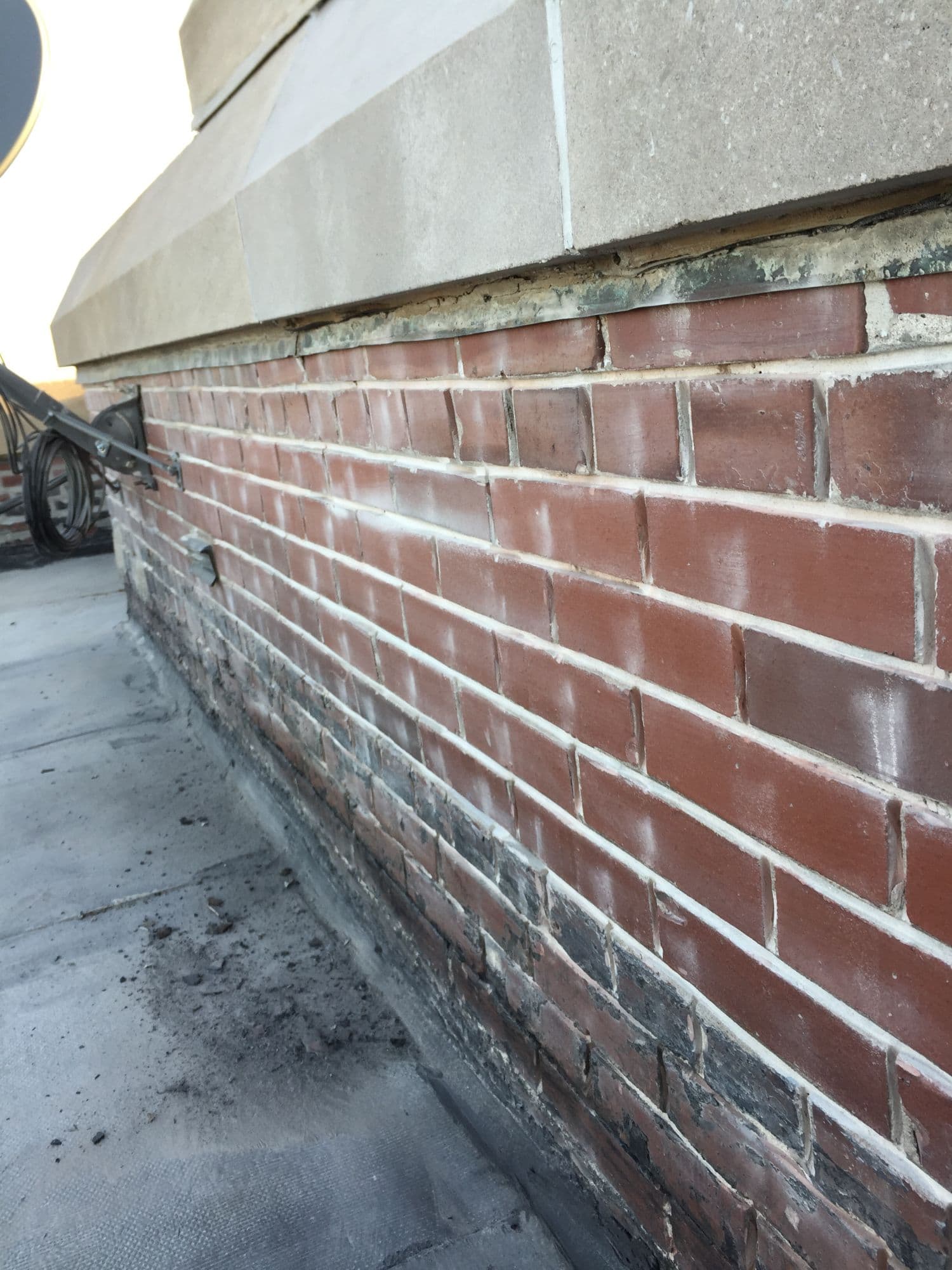 Fresh tuckpointed mortar joints on commercial brick parapet wall North Shore Chicago